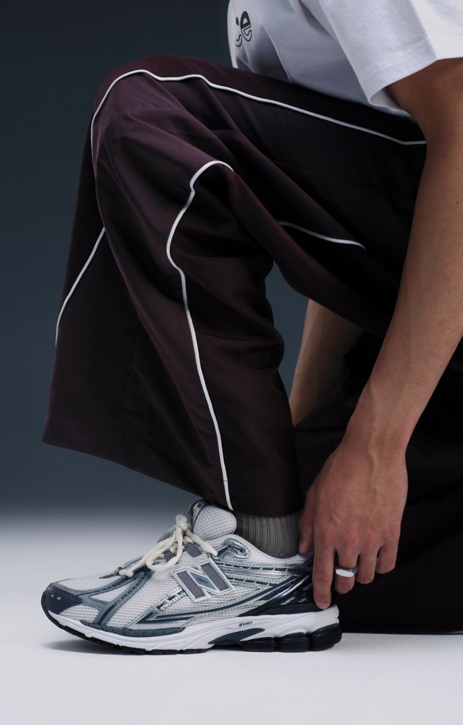 An individual stands wearing the 1906 sneakers